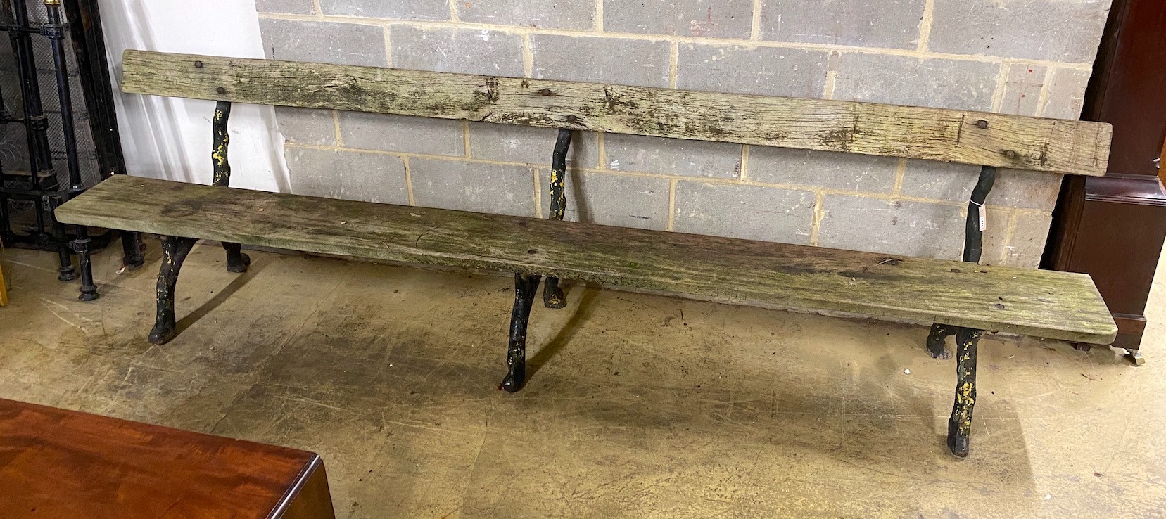 A Victorian cast iron garden bench with rustic ends and teak seat, length 305cm, depth 60cm, height 81cm